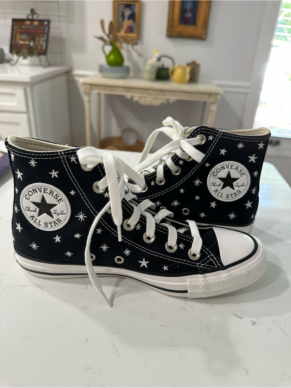 Converse Black High-Top Sneakers with White Embroidered Stars.